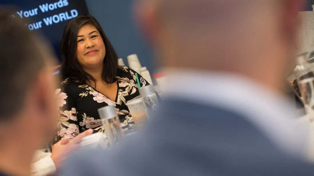 Flor De Maria McNally at a table with agents during a training session