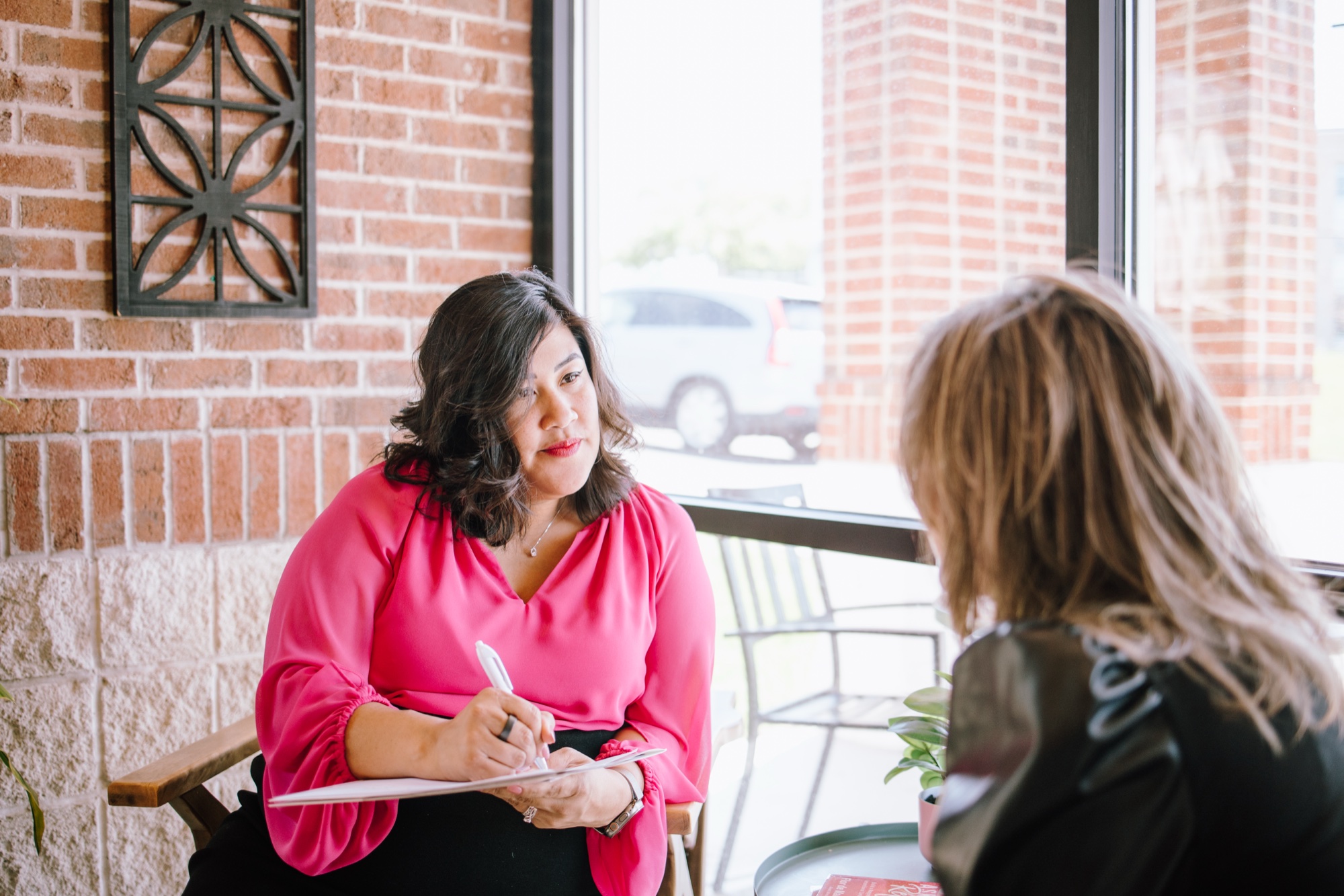Flor sitting down with a client to go over the numbers