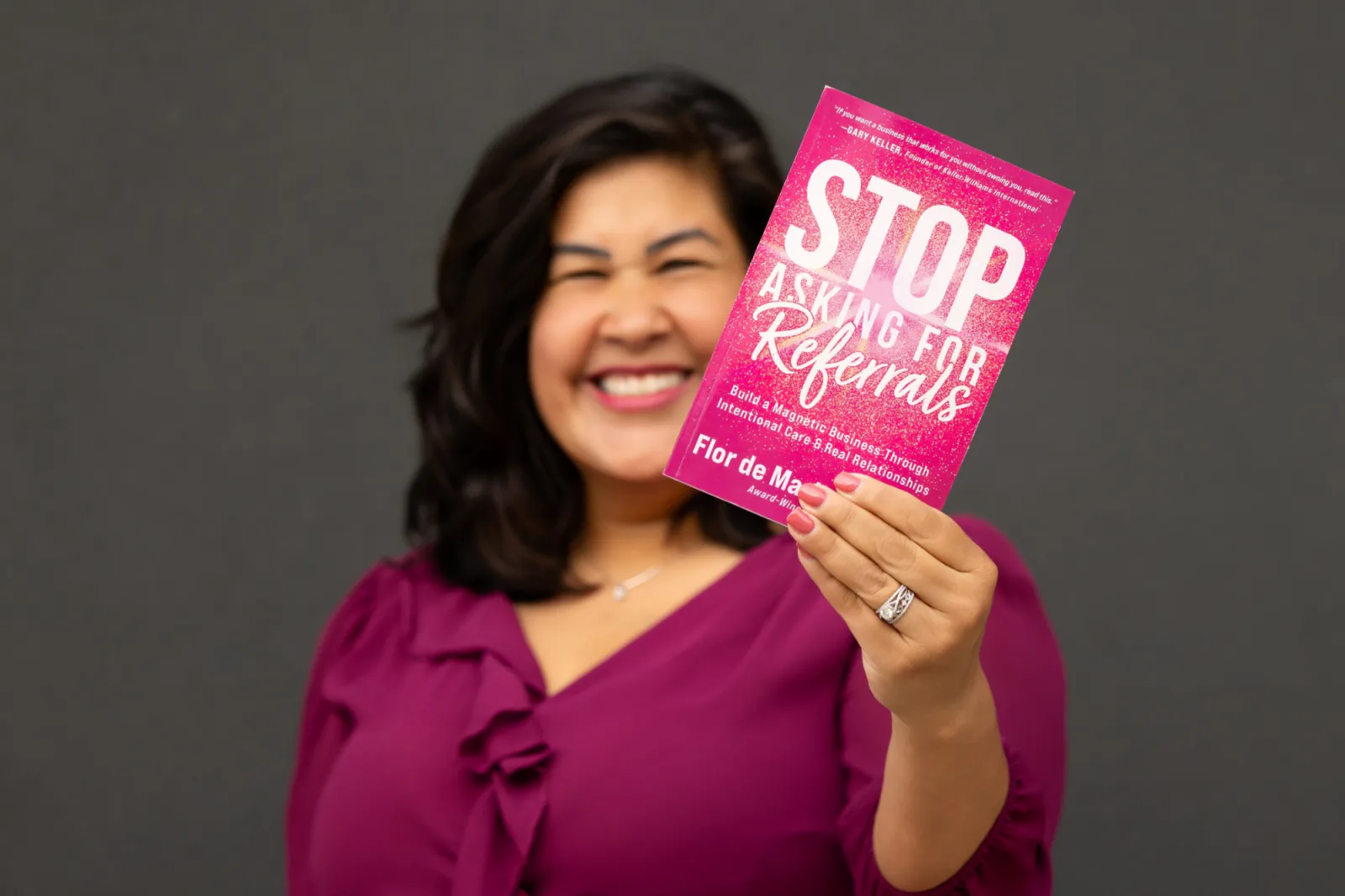 Flor holding her book out toward the camera