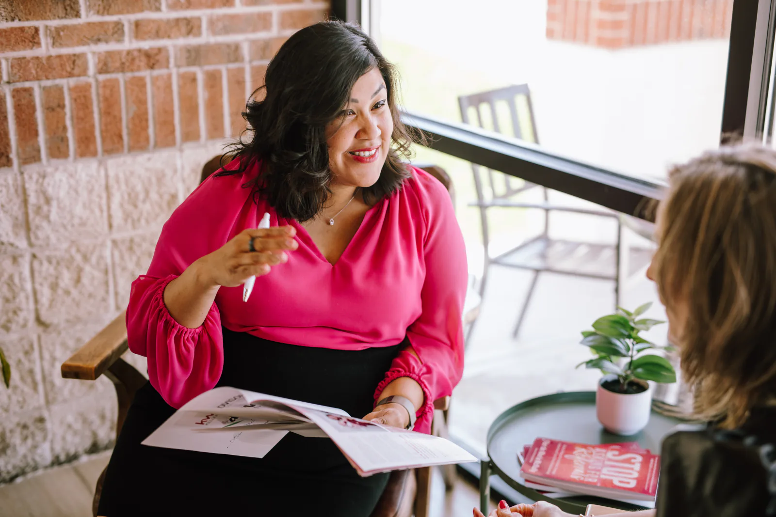 Flor De Maria McNally in a one-on-one strategy session with an agent