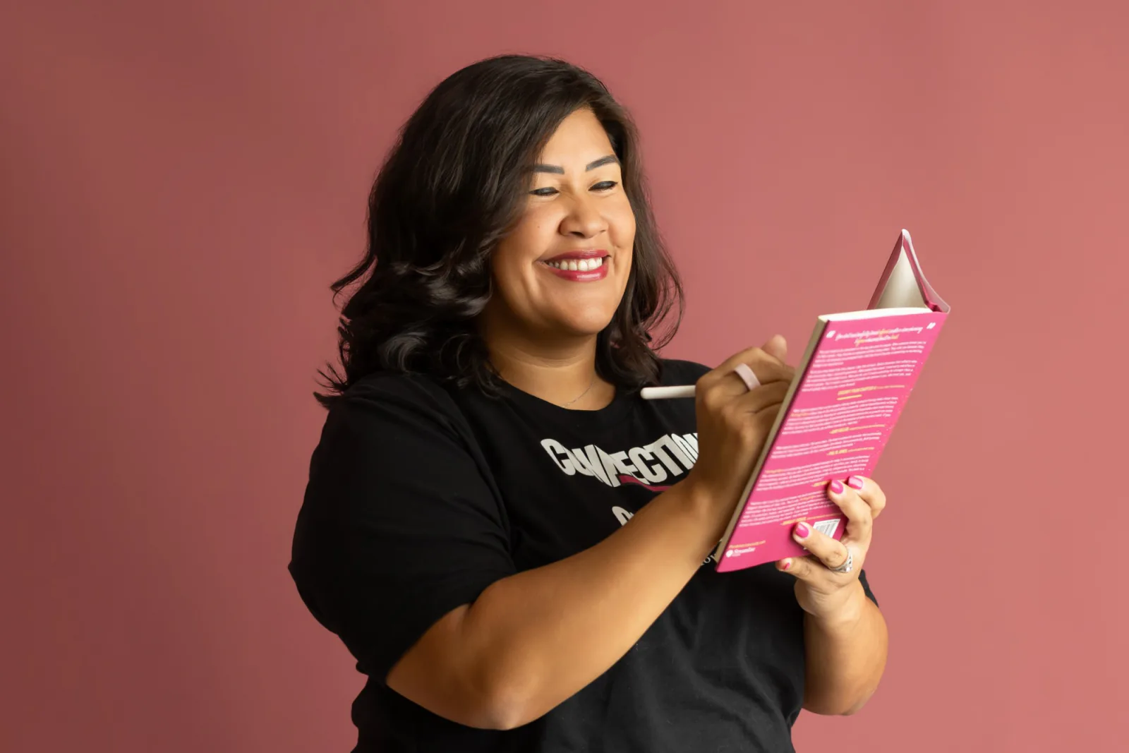 Flor signing a copy of Stop Asking for Referrals