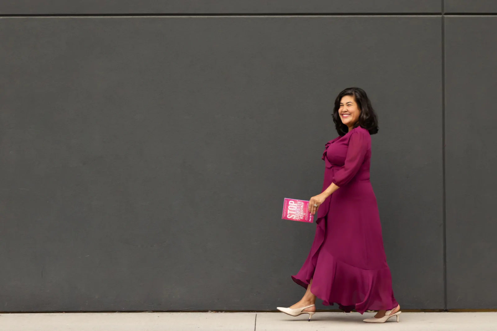 Flor walking down the street with her book